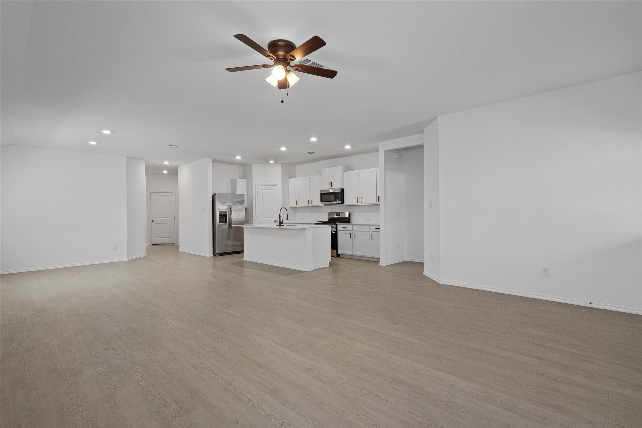 3305 Everett Kyle, TX 78640 - Photo 5 of 21 Open living room featuring a ceiling fan, recessed lighting, and light wood-style flooring