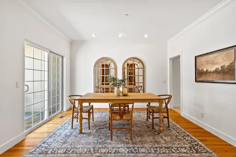 a view of a dining room with furniture window and wooden floor