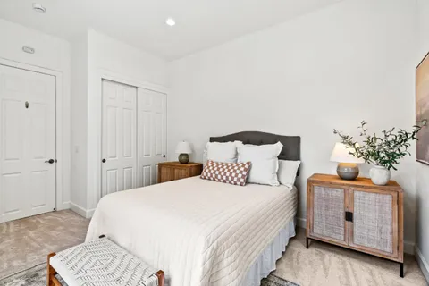 a bedroom with a bed and a chair