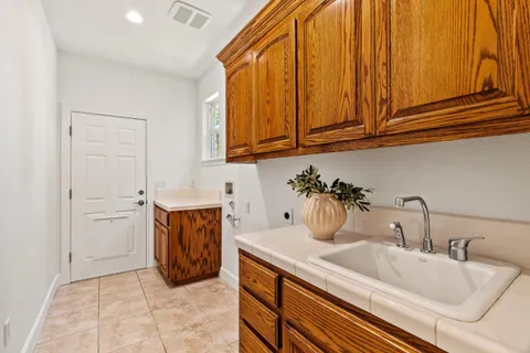 a kitchen with stainless steel appliances granite countertop a sink and cabinets with wooden floor