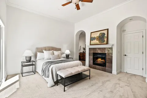 a bedroom with a bed and a fireplace
