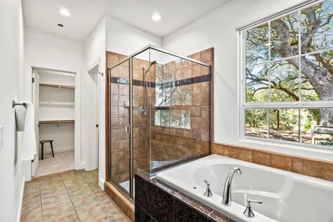 a bathroom with a bathtub and a shower