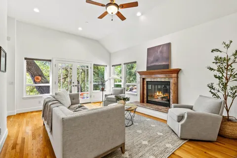 a living room with furniture and a fireplace