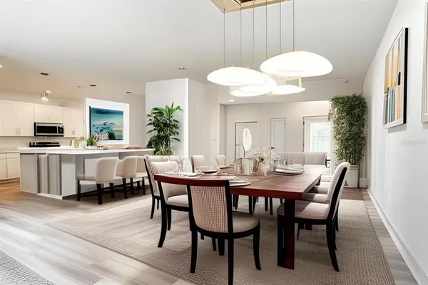a view of a dining room with furniture and wooden floor