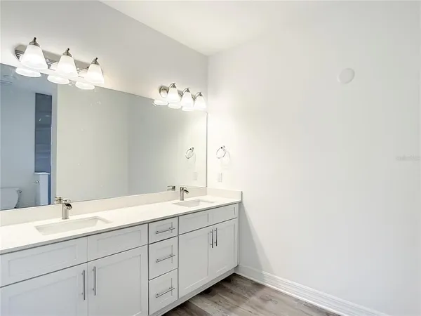 a bathroom with a double vanity sink and a mirror