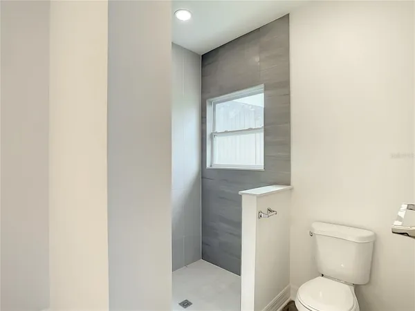 a white toilet sitting next to a bathroom sink