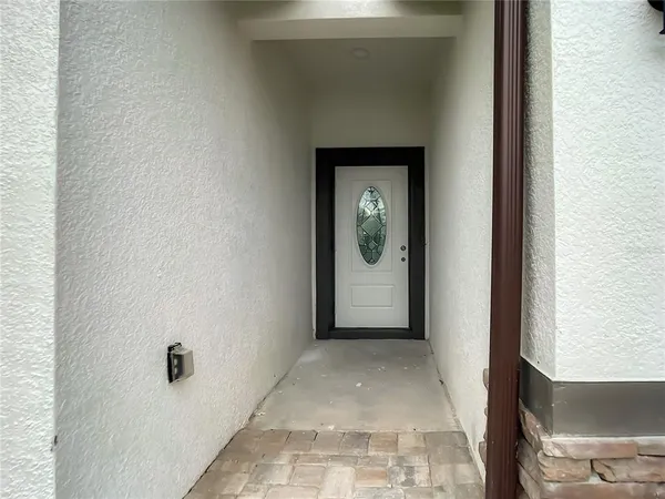 a view of a hallway with a glass door and a floor to ceiling window