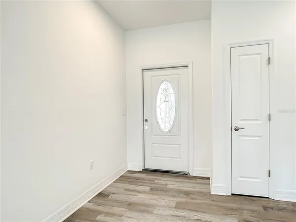a view of a room with wooden floor and white doors