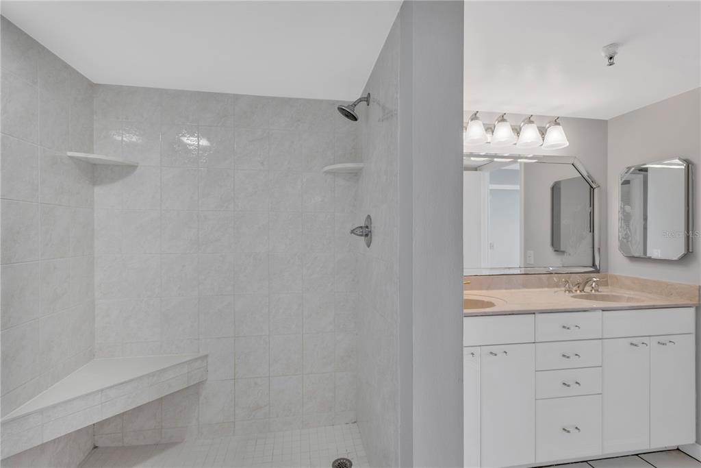 6009 Sea Ranch Drive, Unit 705 Hudson, FL 34667 - Photo 13 of 43 a bathroom with a double vanity sink mirror and bathtub