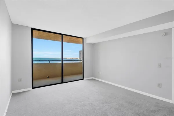 an empty room with sliding glass door