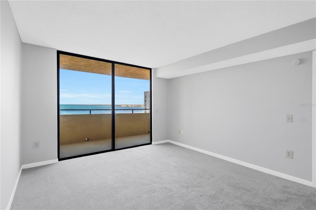 6009 Sea Ranch Drive, Unit 705 Hudson, FL 34667 - Photo 16 of 43 an empty room with sliding glass door
