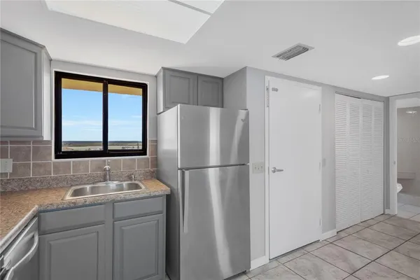 a white refrigerator freezer sitting in a kitchen