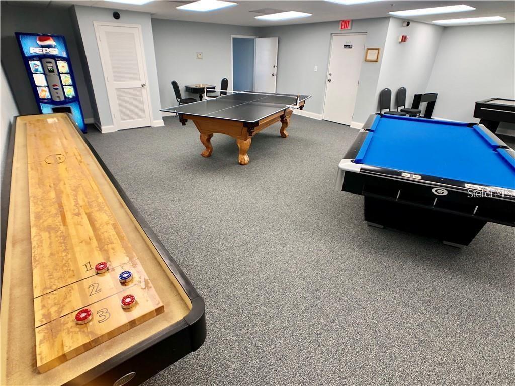 6009 Sea Ranch Drive, Unit 705 Hudson, FL 34667 - Photo 32 of 43 a room with furniture and air hockey table
