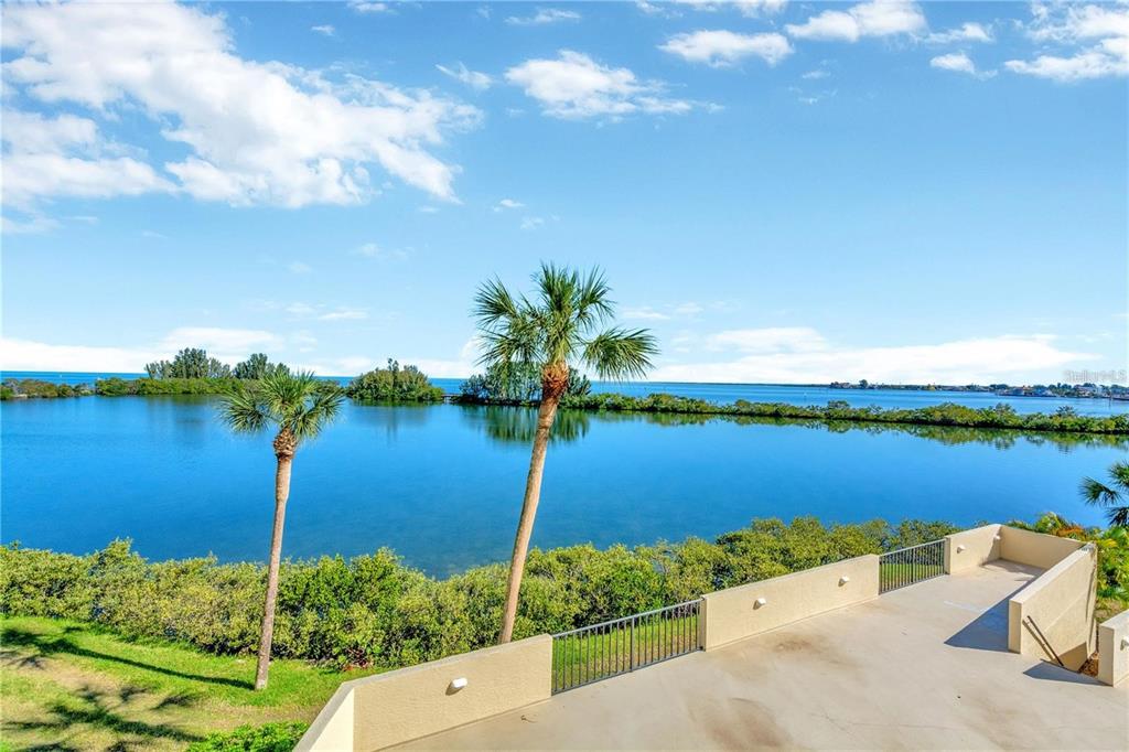 6009 Sea Ranch Drive, Unit 705 Hudson, FL 34667 - Photo 39 of 43 a view of a lake with a house in background