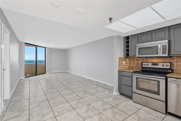 a kitchen with stainless steel appliances granite countertop a stove a microwave and a refrigerator