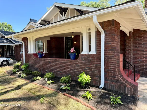 a view of a house with potted plants