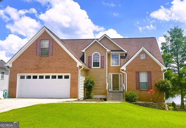 a front view of a house with a yard and garage