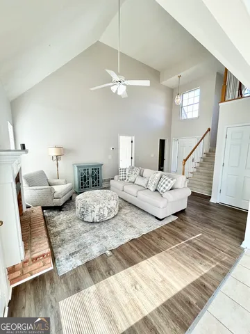 a living room with furniture rug and wooden floor