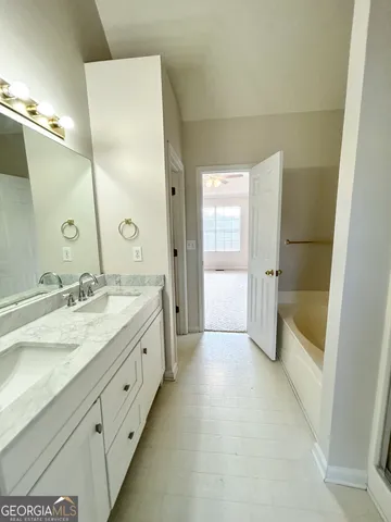 a spacious bathroom with a granite countertop sink a toilet and shower