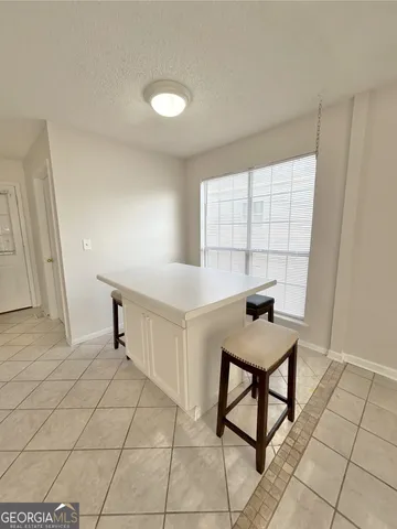 a view of a kitchen with white cabinets