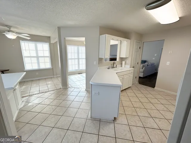 a kitchen with stainless steel appliances a refrigerator sink and stove