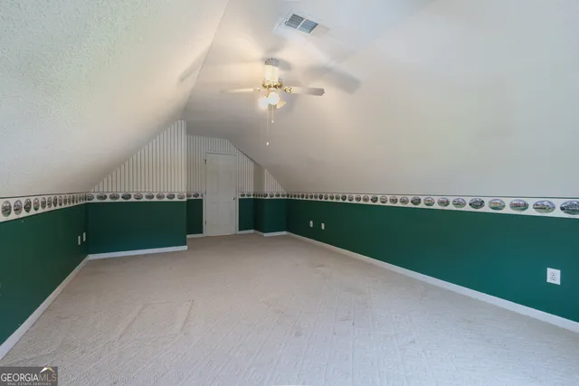 a room with a window and a ceiling fan