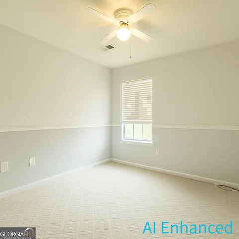 an empty room with windows and ceiling fan