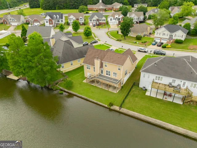 an aerial view of a house with a swimming pool yard and outdoor seating