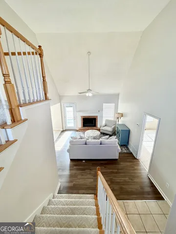 a view of a livingroom with furniture wooden floor and staircase