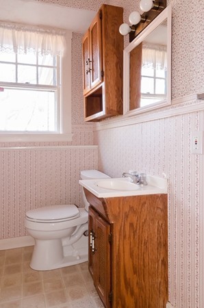 86 Warren Street Needham, MA 02492 - Photo 12 of 24 a bathroom with a toilet a sink and a window