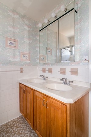 86 Warren Street Needham, MA 02492 - Photo 14 of 24 a bathroom with a sink and a mirror