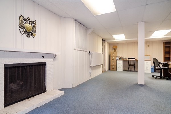 86 Warren Street Needham, MA 02492 - Photo 20 of 24 a view of a livingroom with furniture and an empty room