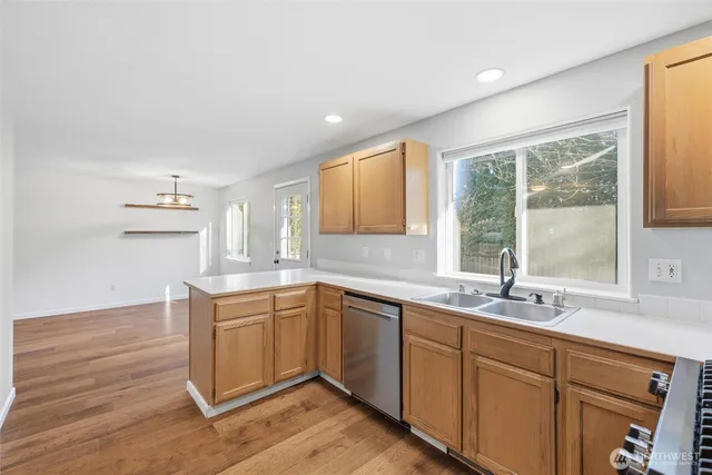 a kitchen with a sink cabinets and window