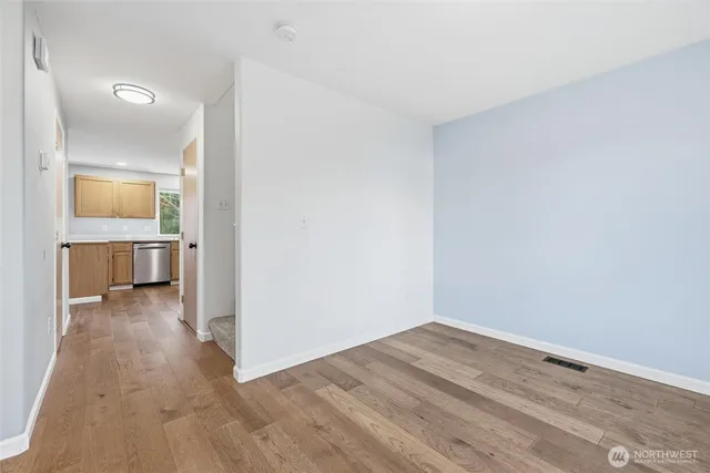 a view of a room with wooden floor and a bathroom sink
