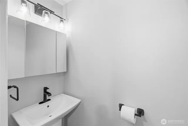 a bathroom with a sink and mirror
