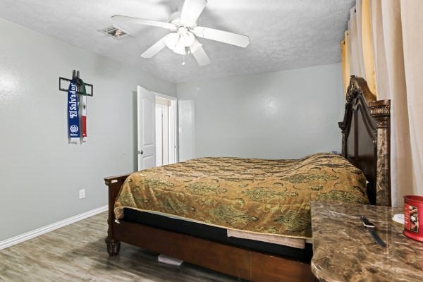 9702 Tiltree Street Houston, TX 77075 - Photo 11 of 24 a bed sitting in a room next to a window