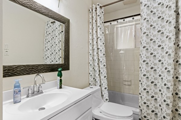 9702 Tiltree Street Houston, TX 77075 - Photo 13 of 24 a bathroom with a sink toilet and shower