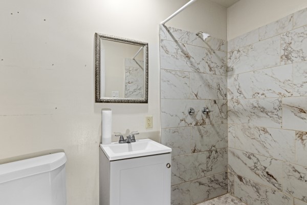 9702 Tiltree Street Houston, TX 77075 - Photo 16 of 24 a bathroom with a sink toilet and vanity