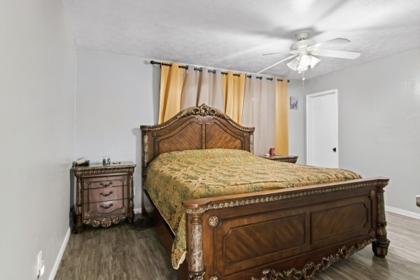 9702 Tiltree Street Houston, TX 77075 - Photo 9 of 24 a bedroom with a bed and a chandelier