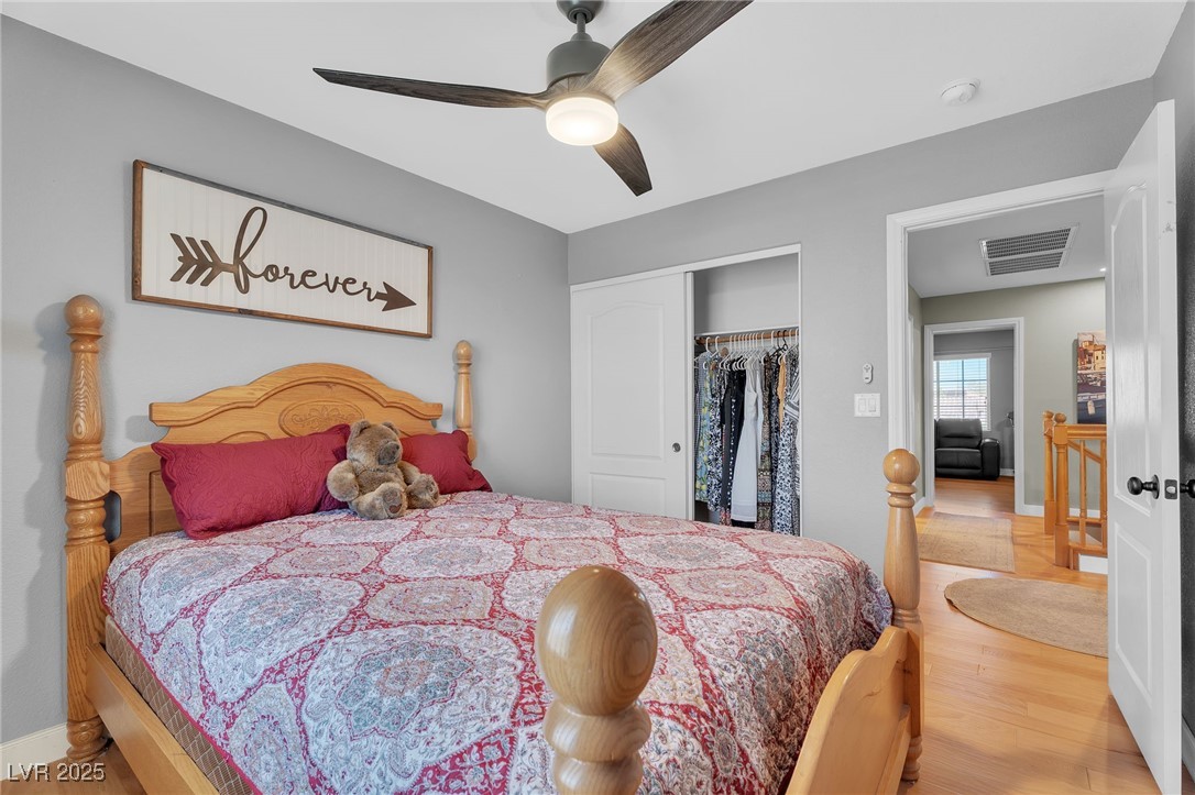 181 Ridge Crossing Avenue Henderson, NV 89002 - Photo 28 of 50 Bedroom with light wood finished floors, a closet, and a ceiling fan