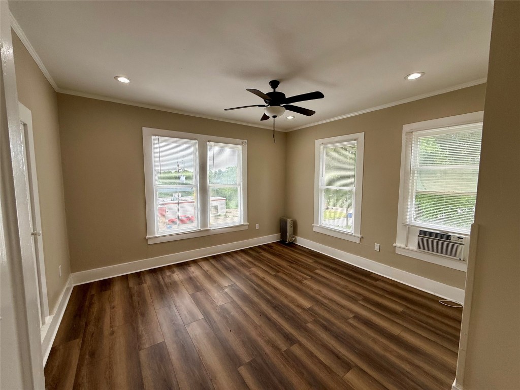 1403 14th Street, Unit 3 Huntsville, TX 77340 - Photo 6 of 9 a view of an empty room with a window and wooden floor