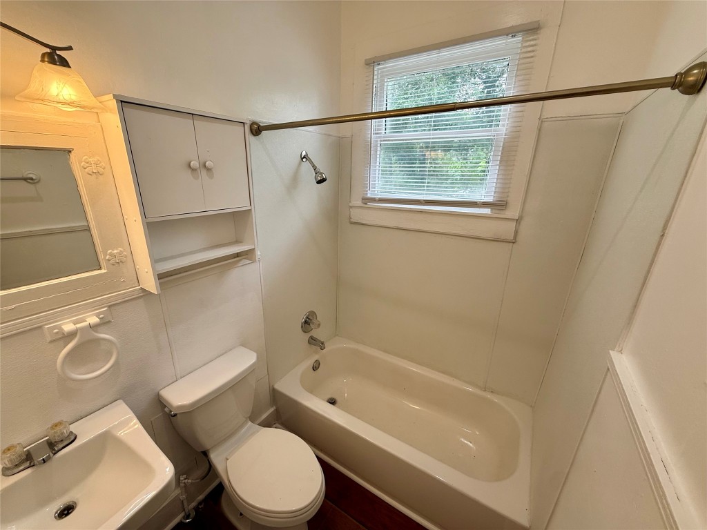 1403 14th Street, Unit 3 Huntsville, TX 77340 - Photo 7 of 9 a bathroom with a toilet and a bathtub