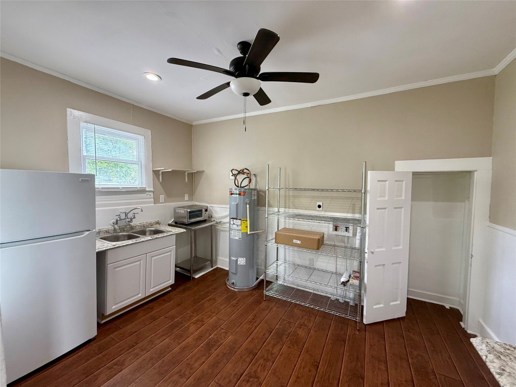 1403 14th Street, Unit 3 Huntsville, TX 77340 - Photo 8 of 9 a kitchen with a refrigerator and a stove top oven