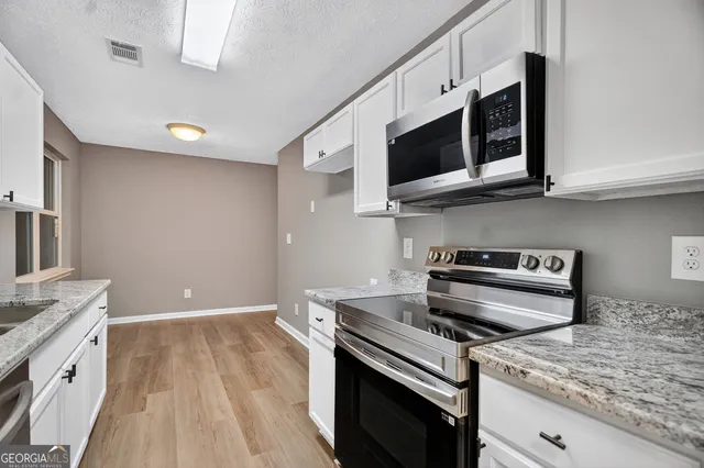 a kitchen with a stove and a microwave