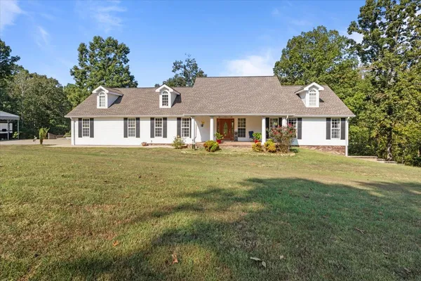 a front view of a house with a garden