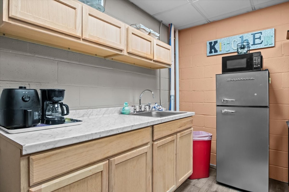 116 Stewart Lane Waverly, TN 37185 - Photo 39 of 87 a kitchen with stainless steel appliances granite countertop a sink and a refrigerator