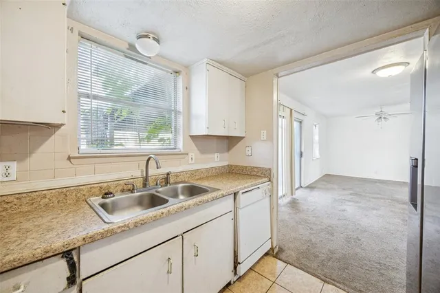 a kitchen that has a sink and a granite counter top