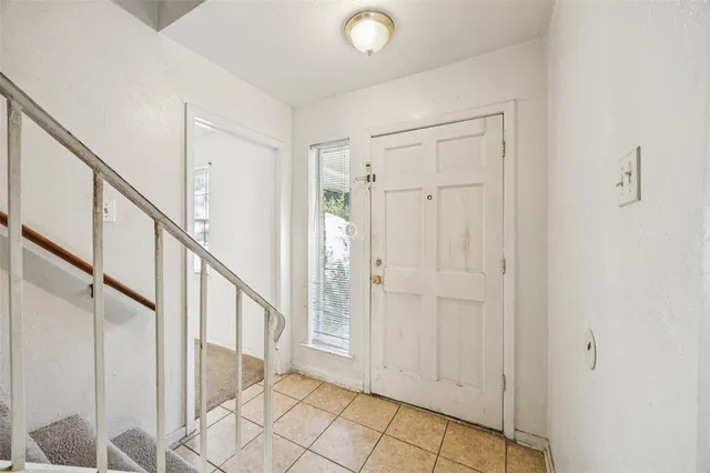 a view of an entryway with wooden floor