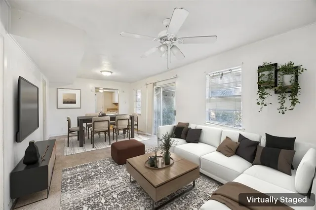 a living room with furniture a table and a flat screen tv