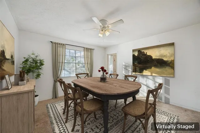 a view of a dining room with furniture and window